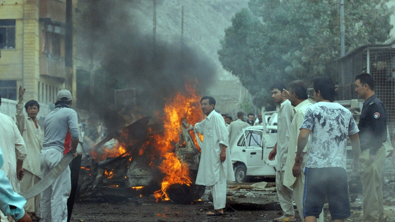 Local residents gather at the site of a car bomb blast in Quetta
