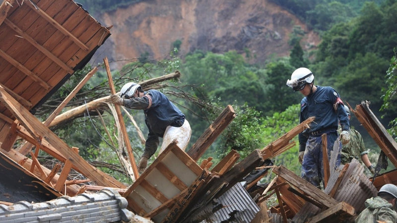 Rescue workers search for missing people in the debris left after typhoon Talas