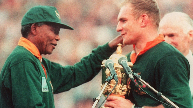 Mandela presenting South Africa captain Francois Pienaar with the World Cup in 1995