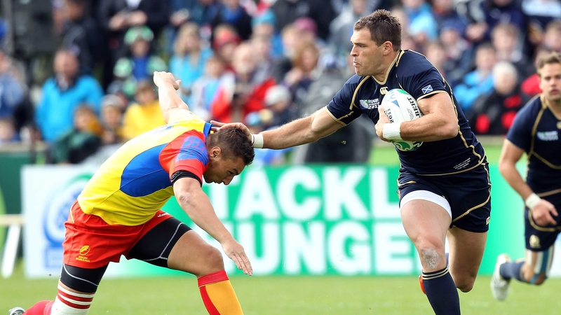 Scotland's Sean Lamont fends off a tackle from Romania's Tiberius Ionut Dimofte