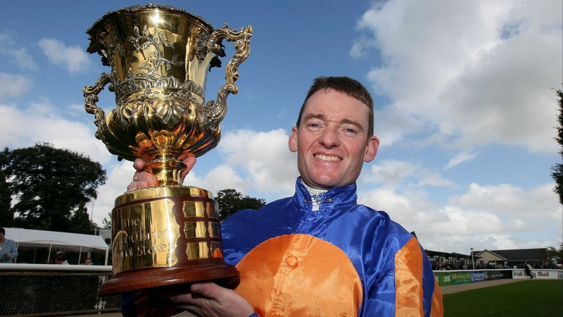 Seamie Heffernan shows off the National Stakes trophy after his victory aboard Power