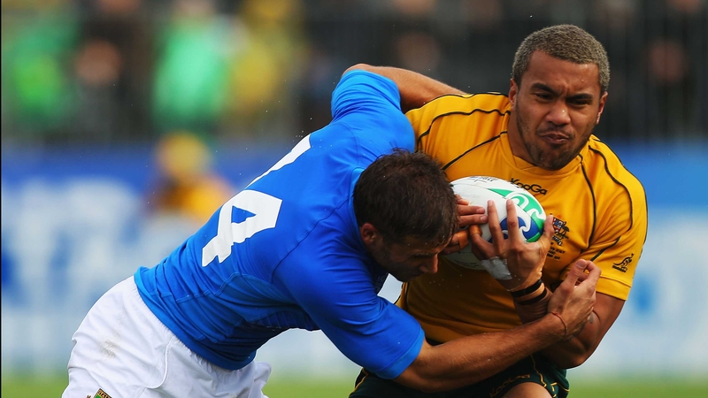 Digby Ioane of Australia is tackled by Tommaso Benvenuti of Italy