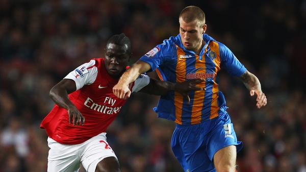 Emmanuel Frimpong of Arsenal tangles with Shrewsbury's James Collins