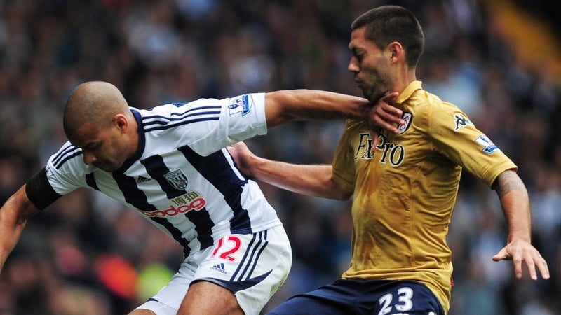 Clint Dempsey (R) of Fulham battles for the ball with Steven Reid of West Brom