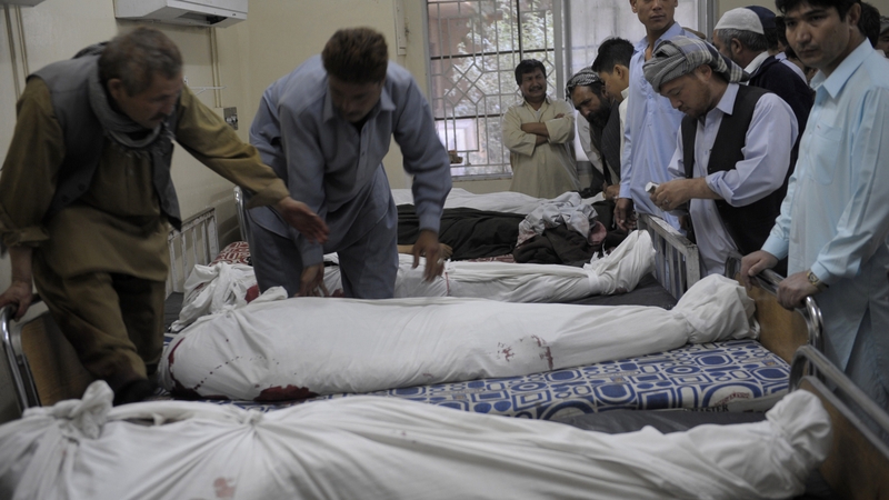 Pakistani Shia Muslim mourners place the dead bodies of their community members in a hospital in Quetta
