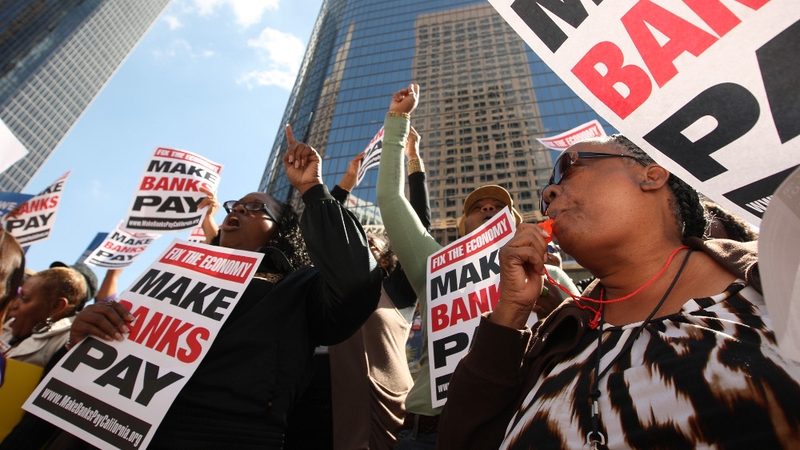 Protesters make their feelings known outside a bank in Los Angeles