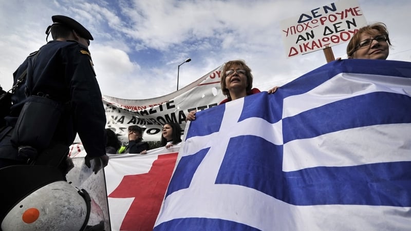Greece protests continue as trioka approves next aid tranche