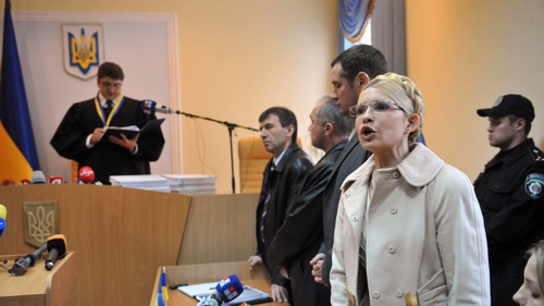 Yulia Tymoshenko speaks to reporters as the judge reads his judgment