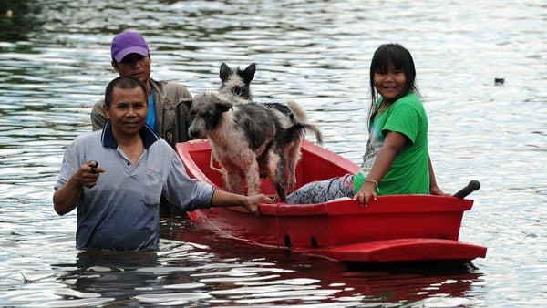People try to wade through the water in Bangkok
