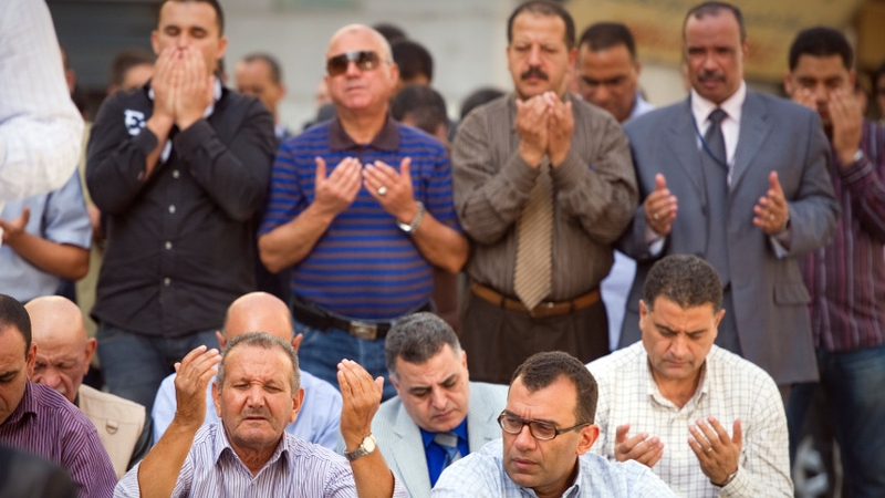 Tunisians pray during the Friday prayers ahead of Sunday's election
