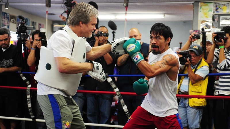 Manny Pacquiao (R) works out with trainer Freddie Roach at Wildcard Boxing Club in Hollywood yesterday