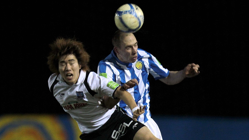 Monaghan's Alan Byrne (R) with Jin Gu Kim of Galway United