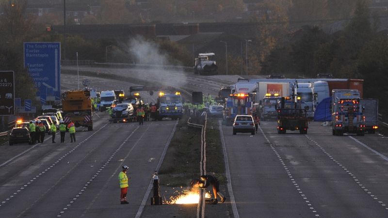 A welder repairs a central barrier on the motorway