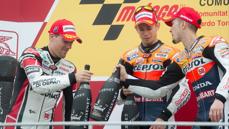 (Left to right) Ben Spies of Yamaha Factory Racing; Casey Stoner of Repsol Honda Team; and Andrea Dovizioso of Repsol Honda Team celebrate on the podium at the end of the MotoGP race in Valencia