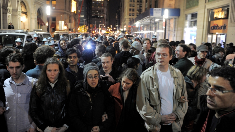 People link arms a few blocks from Zuccotti Park as New York City officials clear the 'Occupy Wall Street' protest