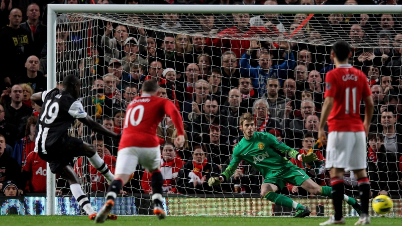 Demba Ba slots home the penalty that gave Newcastle a point at Old Trafford