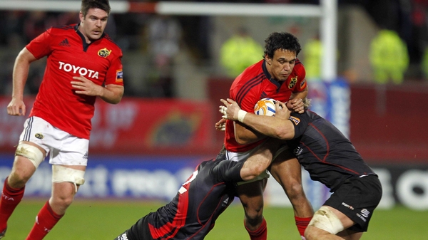Munster's Will Chambers is tackled by Steven Lawrie and Ross Rennie