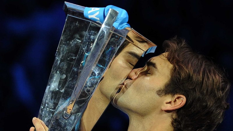 Roger Federer says hello to the ATP World Tour Finals singles trophy