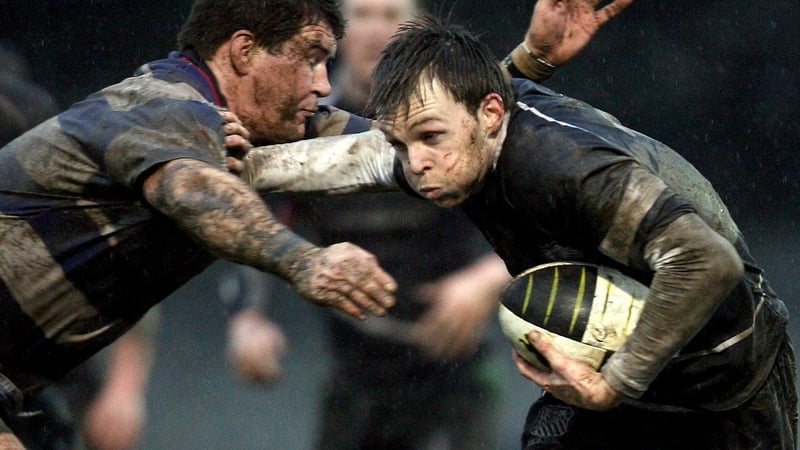 Old Belvedere's John Kennedy evades Mick Carroll of Blackrock College