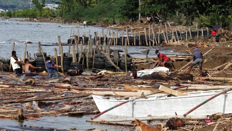 Survivors salvage debris left after the passage of tropical storm Washi