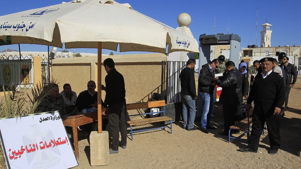 Egyptian voters go through a security inspection at the entrance to a polling station in the Red Sea city of Sharm el-Sheikh