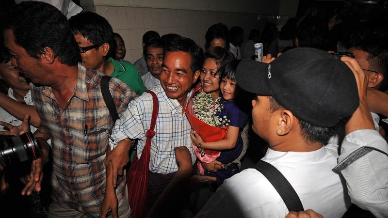 Myanmar political prisoner Zaw Thet Htwe (C) is welcomed by relatives upon his arrival at Yangon international airport