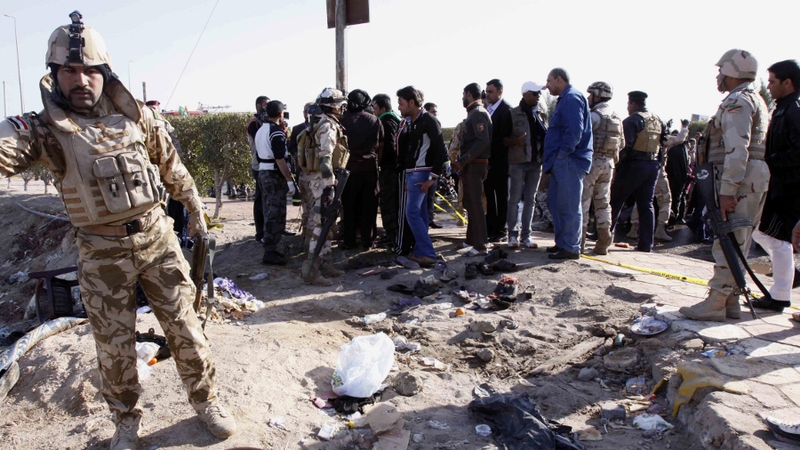 Iraqi soldiers examine the scene of the blast in Basra