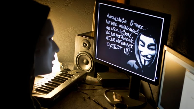 A masked hacker, part of the Anonymous group, hacks the French presidential Elysee Palace website on 20 January