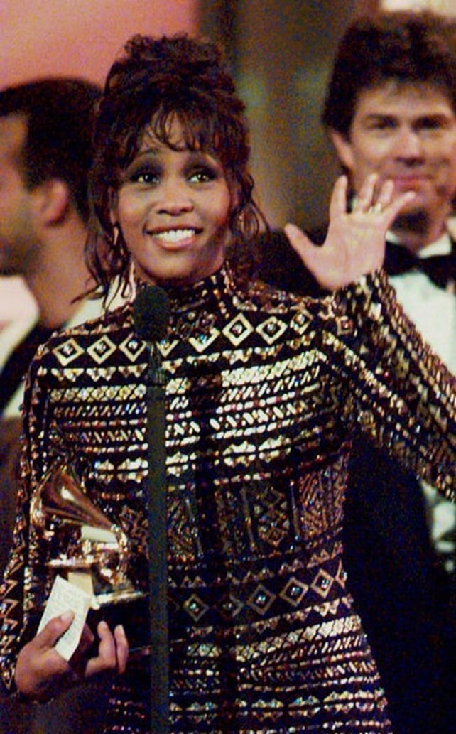 Waving to the crowd at the Grammys in 1994 after her Bodyguard, I'll Always Love You song win
