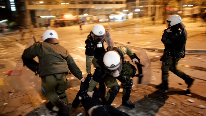 Police arrest a protester in the streets during the demonstrations