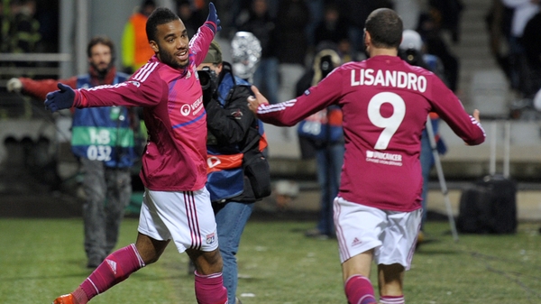 Alexandre Lacazette celebrates Lyon's winner with team-mate Lisandro Lopez