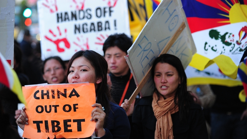 Pro-Tibetan demonstrators protest against Chinese-ruled Tibet in front of a downtown hotel in Los Angeles