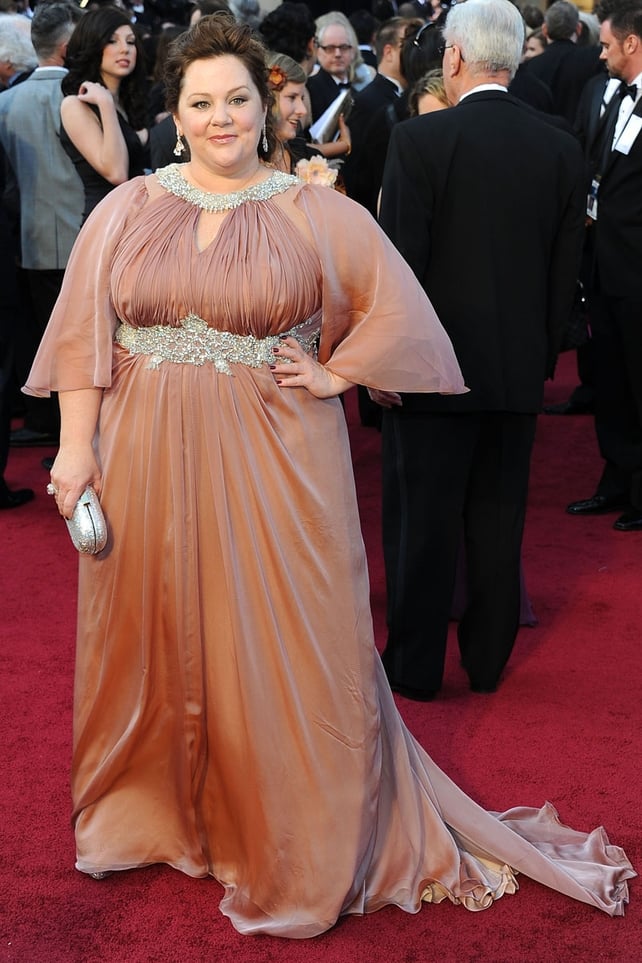 Melissa McCarthy: Battling sickness earlier this week, McCarthy turned it out on the runway wearing this peach Marina Rhaldi dress with beautiful auburn hair. However the sleeves are making her arms twice their size, without them this would have been grea