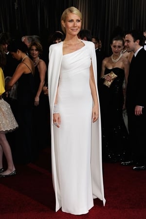 Gwyneth Paltrow: Wearing a Tom Ford white, one-shoulder dress with added cape detail this is a risky yet conservative look for Gwyneth and we think she looks impeccable