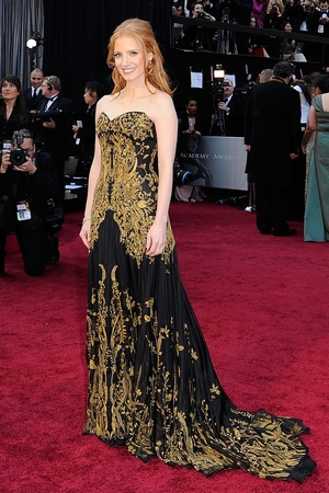 Jessica Chastain: Wow. In custom-made Alexander McQueen, Chastain has taken a huge risk. This black gown with gold filigree detail was custom made by Sarah Burton and The Help star wore her gorgeous hair long to top off this look. This is something we've