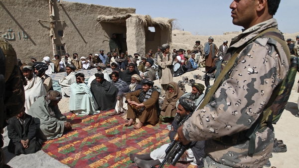 Afghan men at a memorial service for the 16 slain villagers