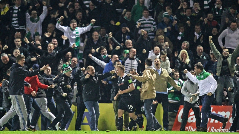 Shamrock Rovers players are mobbed by the Hoops fans after Gary Twigg grabbed a last-minute equaliser at Turner's Cross