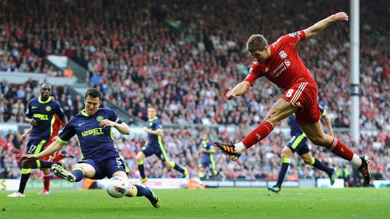 Steven Gerrard fires in a shot under pressure from Gary Caldwell
