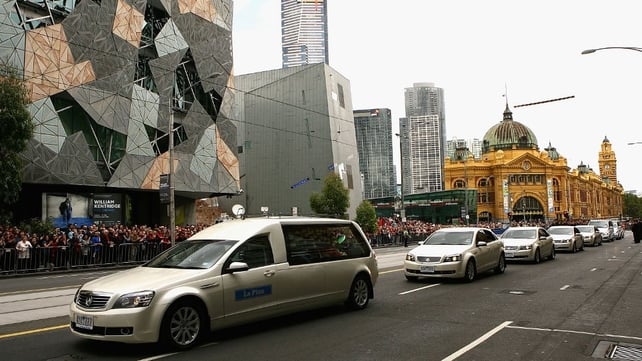 The funeral procession heads down Finders Street en route to a scheduled stop at the Melbourne Cricket Ground