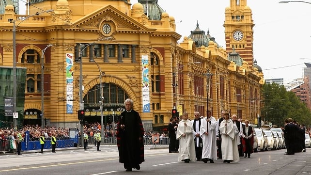 The funeral procession proceeds on Flinders Street