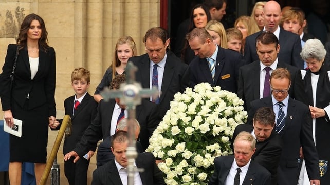 The coffin of Jim Stynes is carried out of the catherdal