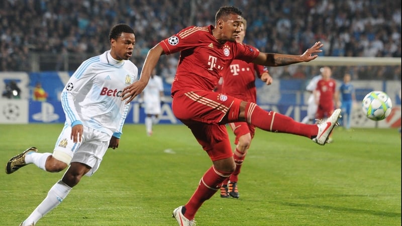 Bayern's Jerome Boateng clears under pressure from Loïc Remy
