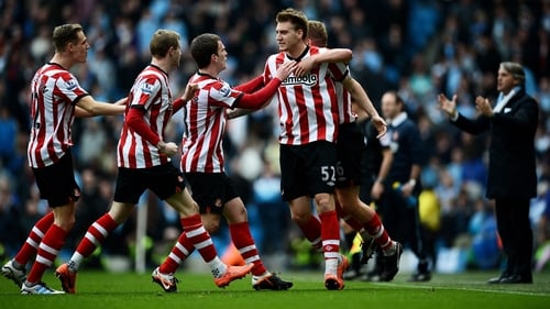 Nicklas Bendtner is mobbed after putting Sunderland 2-1 up