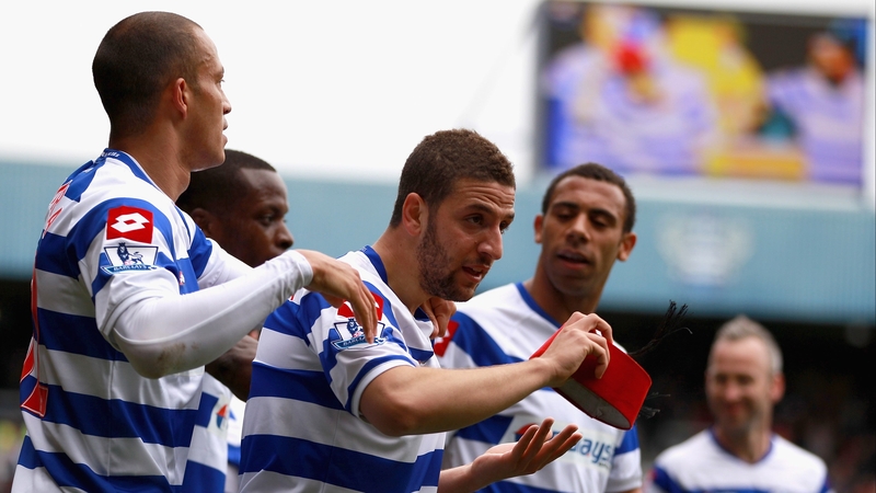 What's all the fez about? Moroccan Adel Taarabt celebrates his goal by donning a red fez and then throwing it to the crowd - an action for which he received a yellow card.