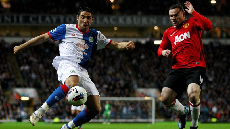 Bradley Orr and Wayne Rooney in action during tonight's fixture at Ewood Park