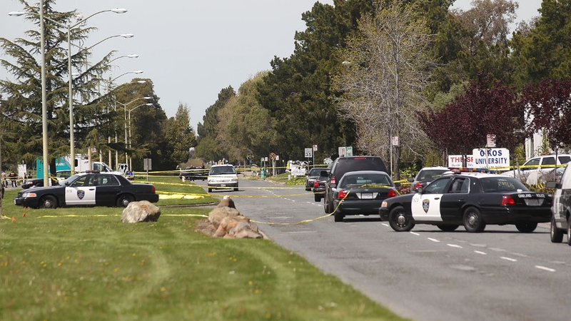 The covered bodies of some of the shooting victims at Oikos University