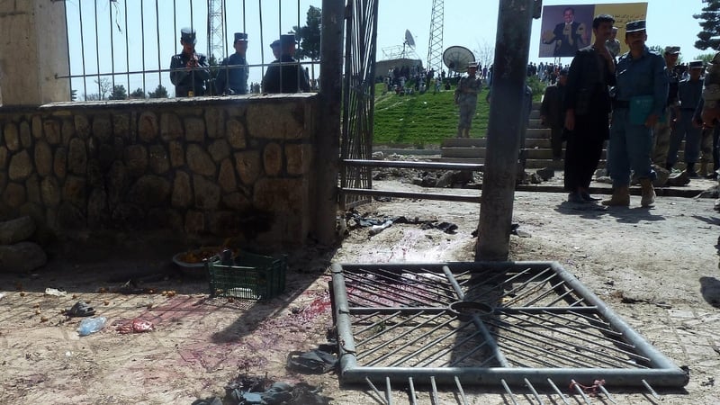 Security officials inspect the aftermath of the suicide bomb in Faryab