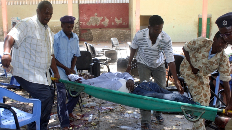 A victim of a suicide attack is carried on a stretcher