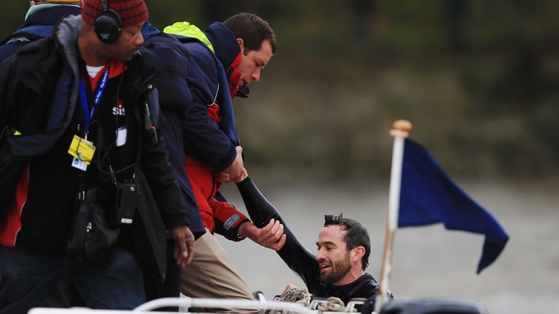 Trenton Oldfield is pulled from the water after swimming in front of the crews and disrupting the Xchanging University Boat Race between Oxford and Cambridge