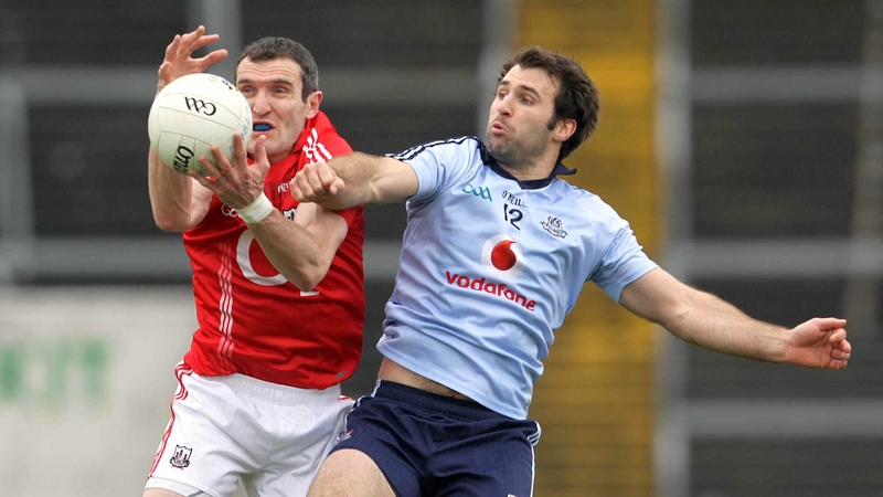 Graham Canty of Cork and Bryan Cullen of Dublin battle for possession